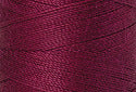 A swatch of Mettler Silk Finish 50 Thread Pomegranate 0869