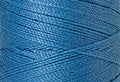 A swatch of Mettler Silk Finish 50 Thread Reef Blue 0338