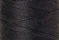 A swatch of Mettler Silk Finish 50 Thread Mole Gray 0348