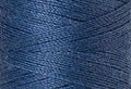 A swatch of Mettler Silk Finish 50 Thread Smoky Blue 0351