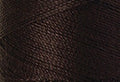 A swatch of Mettler Silk Finish 50 Thread Very Dark Brown 1002