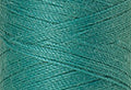 A swatch of Mettler Silk Finish 50 Thread Deep Aqua 1091