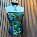 Mannequin wearing a floral and animal print top against a striped background