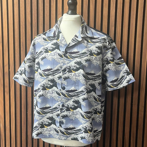 Hawaiian shirt with wave pattern on a mannequin against a wooden slat background made at TMS